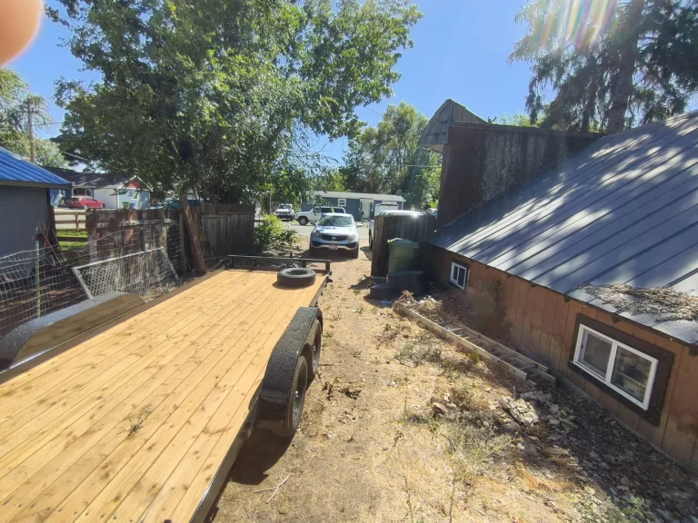 Backyard with a utility trailer next to the house
