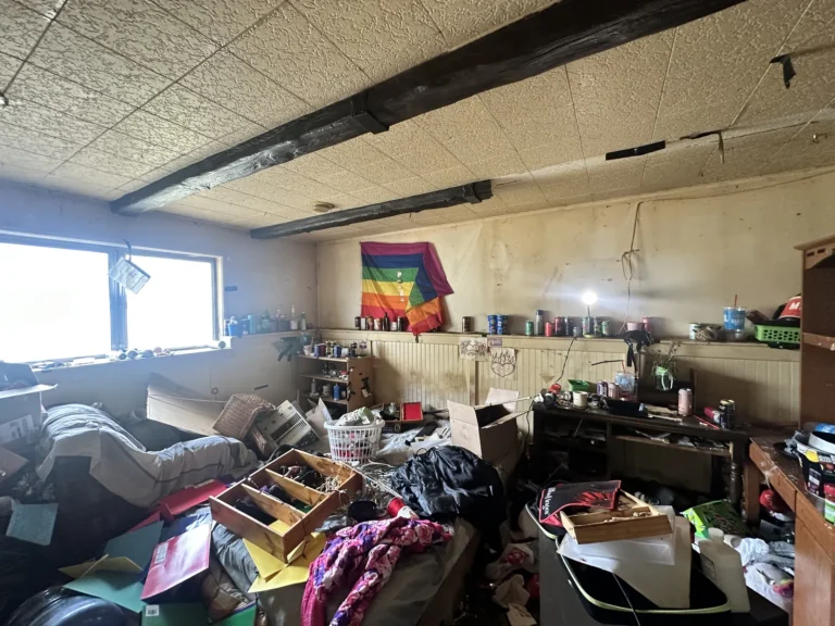 Large room packed with belongings and furniture