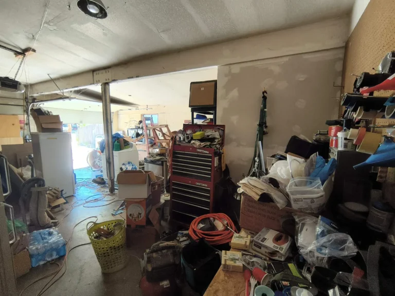 Garage packed with tools, boxes and furniture