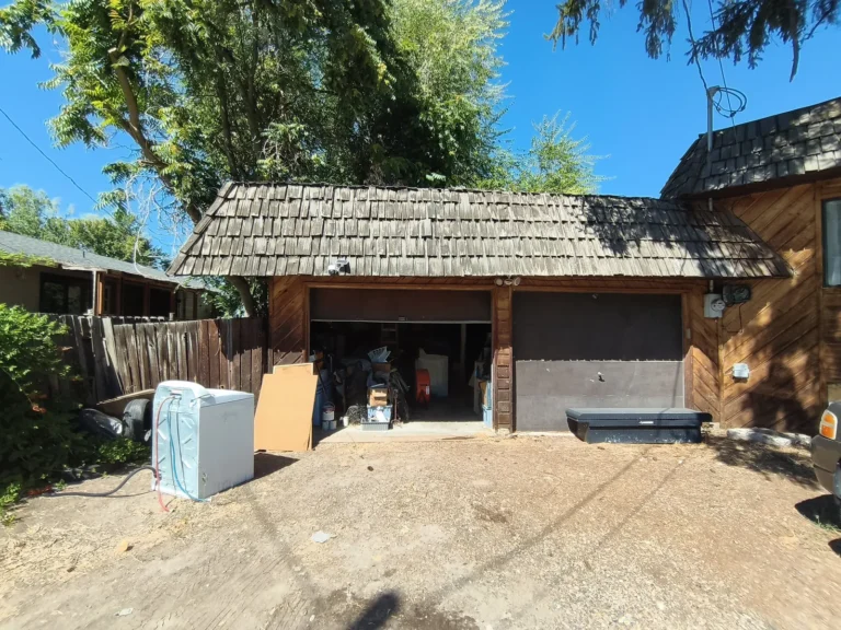 Detached garage with old appliances out front