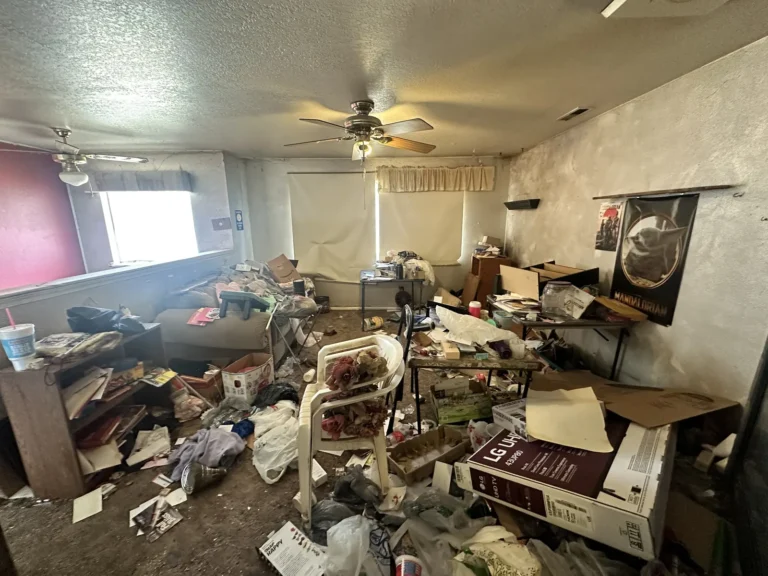 Living room buried in clutter before a cleanout