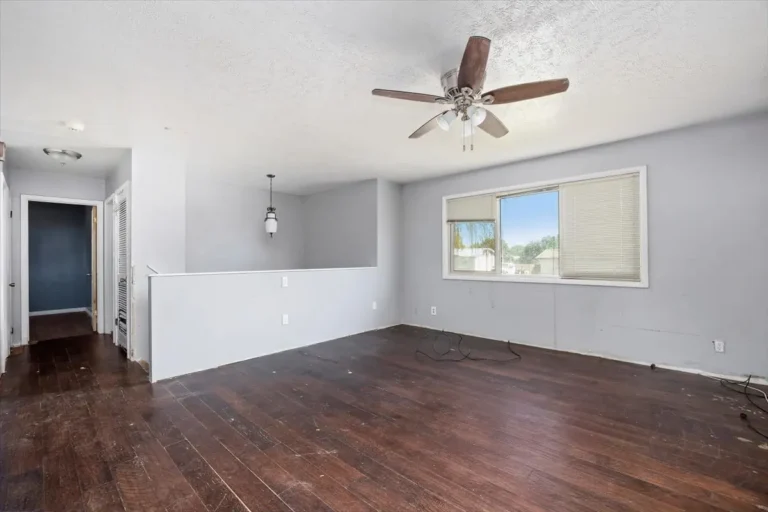 Open living room leading to a hallway
