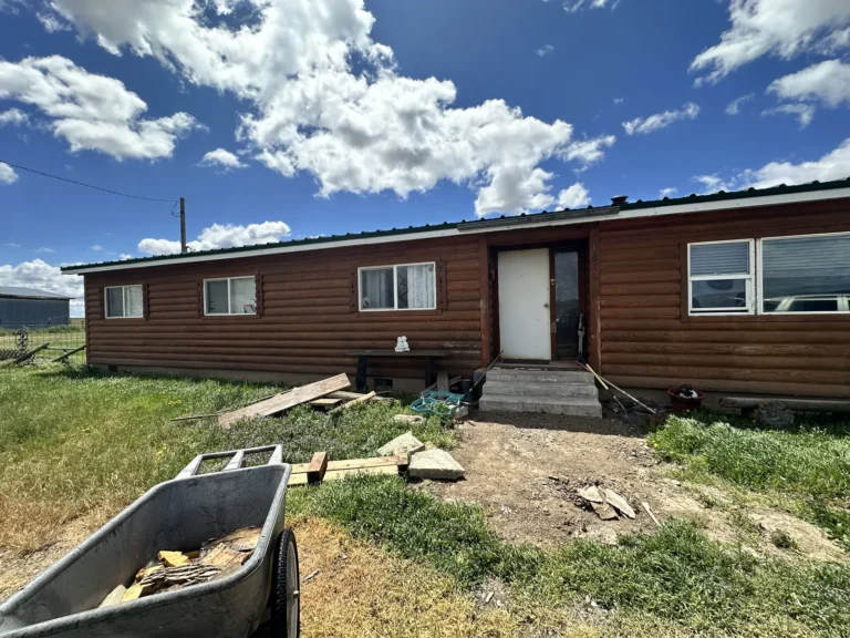 Ranch house with a cleanout dumpster in the front yard